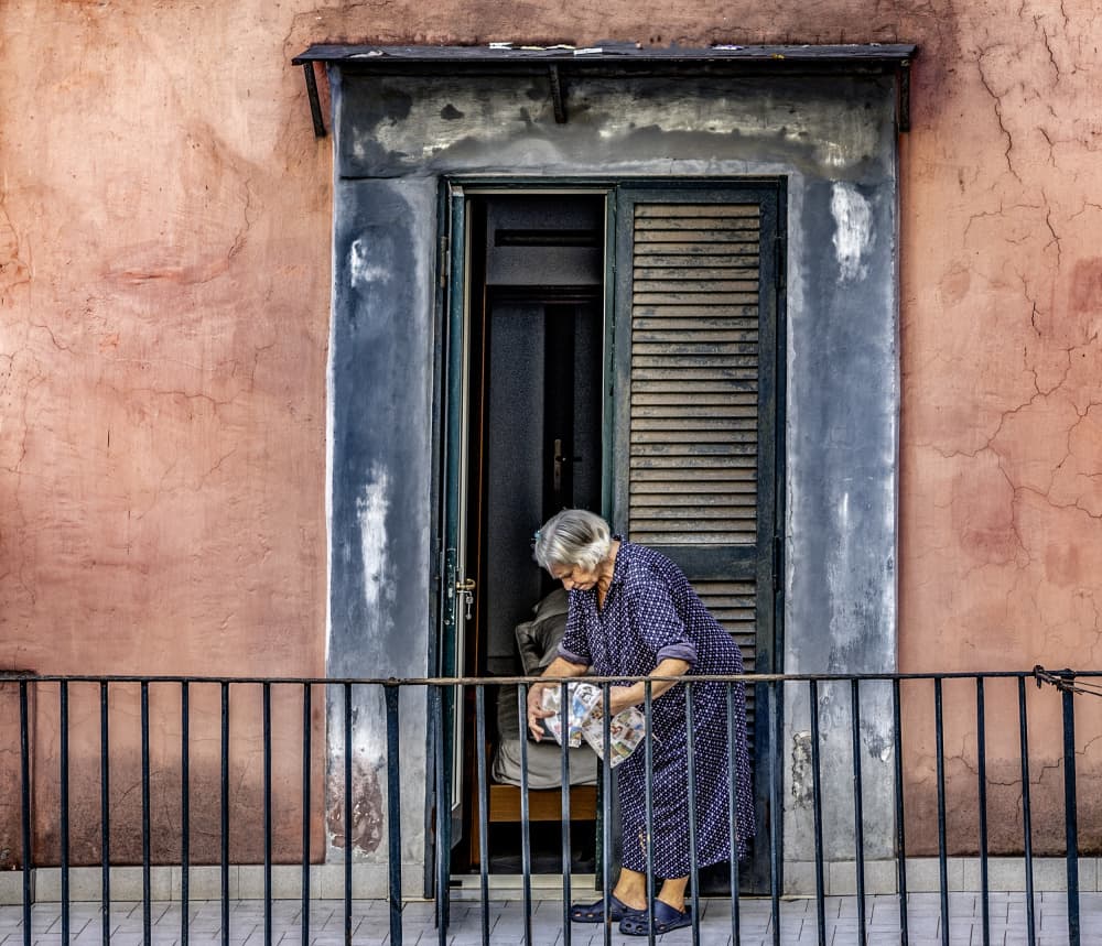Elderly Woman Balcony Life by Ömer Ates Kızıltug — canvas wall art