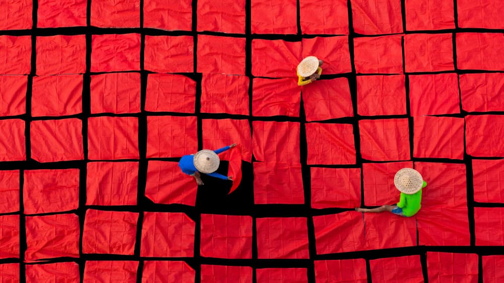 Red Fabric Workers by Nilendu Banerjee — canvas wall art