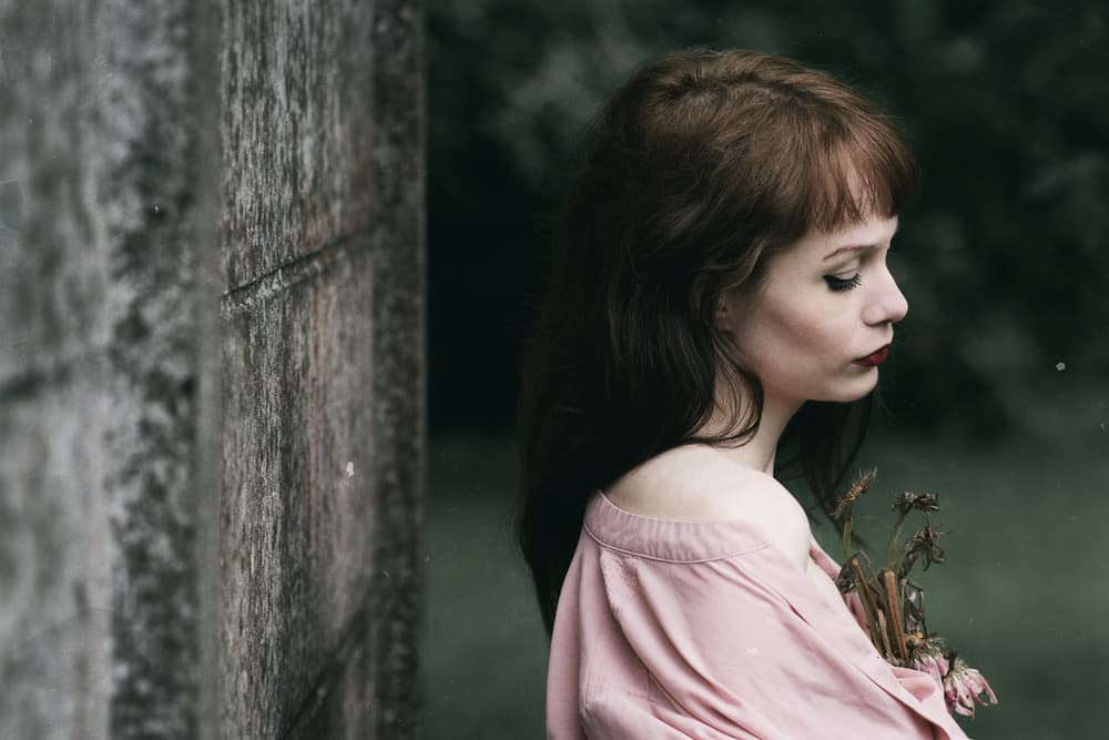 Melancholy Woman With Flowers by Jacob Tuinenga — canvas wall art