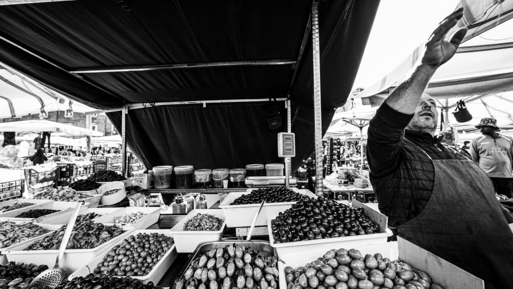 Market Vendor Selling Olives by Rosario Leonardi — canvas wall art