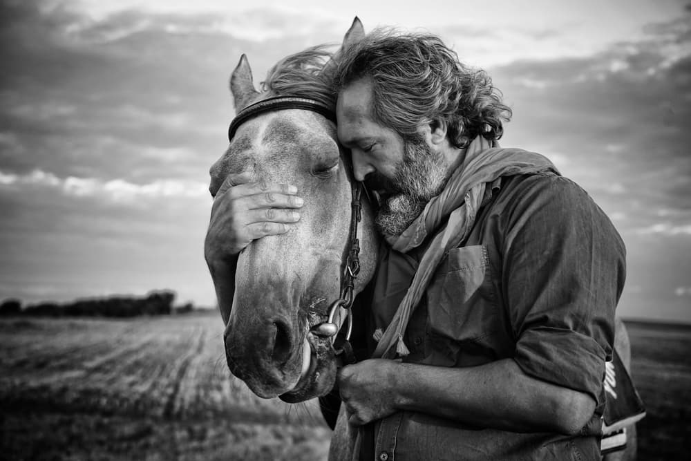 Man And Horse Embrace by Gilcan Mete — canvas wall art
