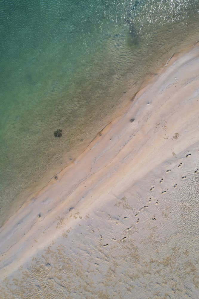 Tranquil Beach Footprints by Anna Kirchner — canvas wall art