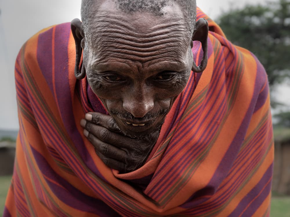 masai man welcoming me to his village by Elena Molina — canvas wall art