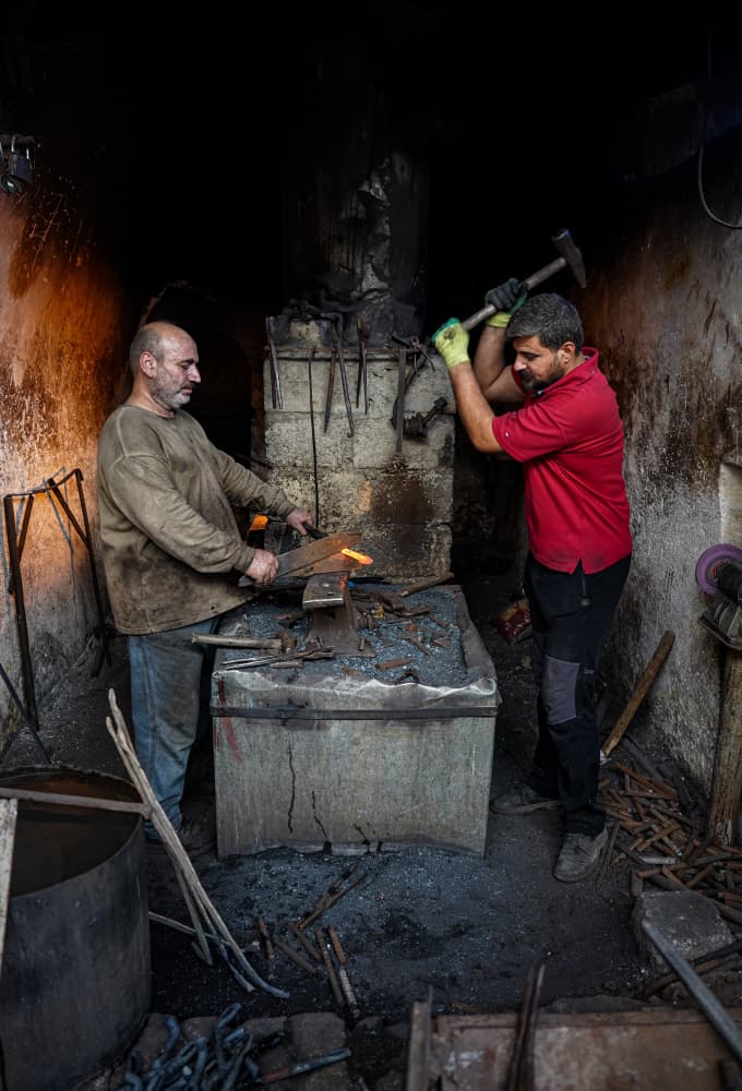 Blacksmiths Forging Metal by Bashar Alsofey — canvas wall art