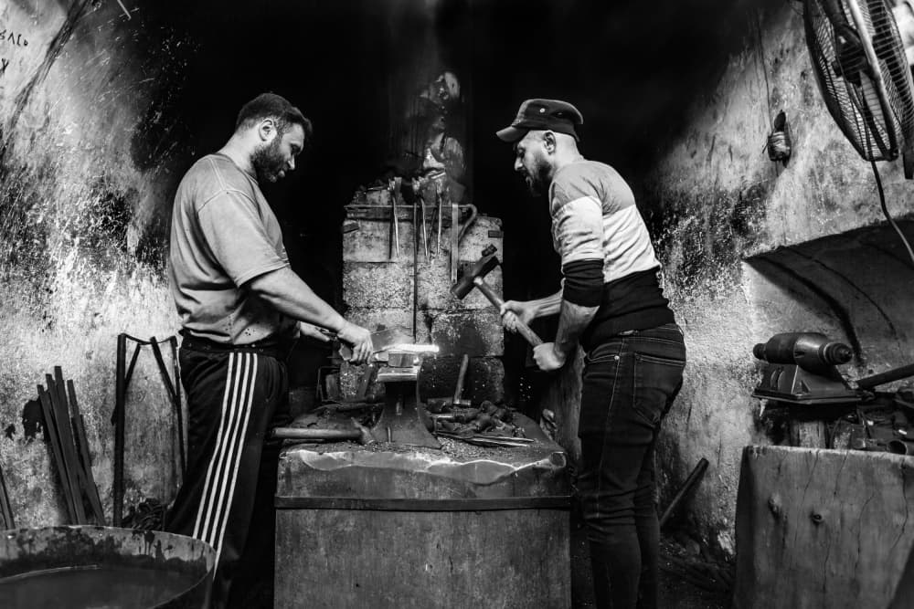 Blacksmiths at the Forge by Saad Salem — canvas wall art