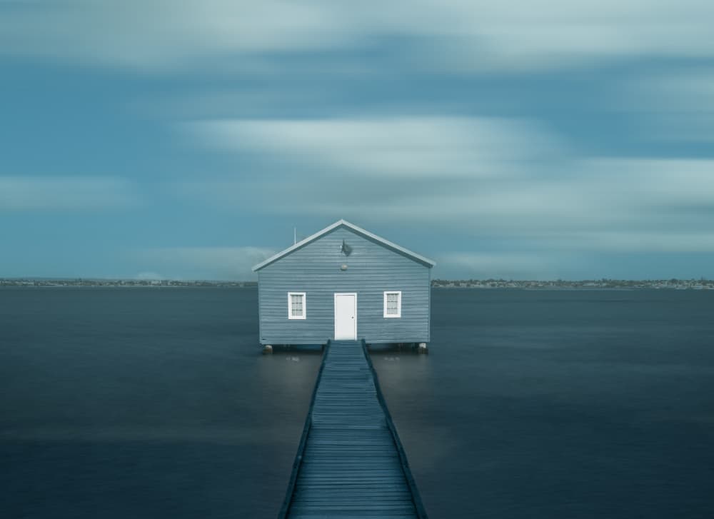 Tranquil Blue Boathouse by May G — canvas wall art