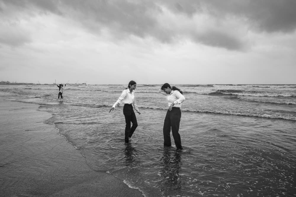 Girls Wading Ocean Waves by Subhajit Das — canvas wall art