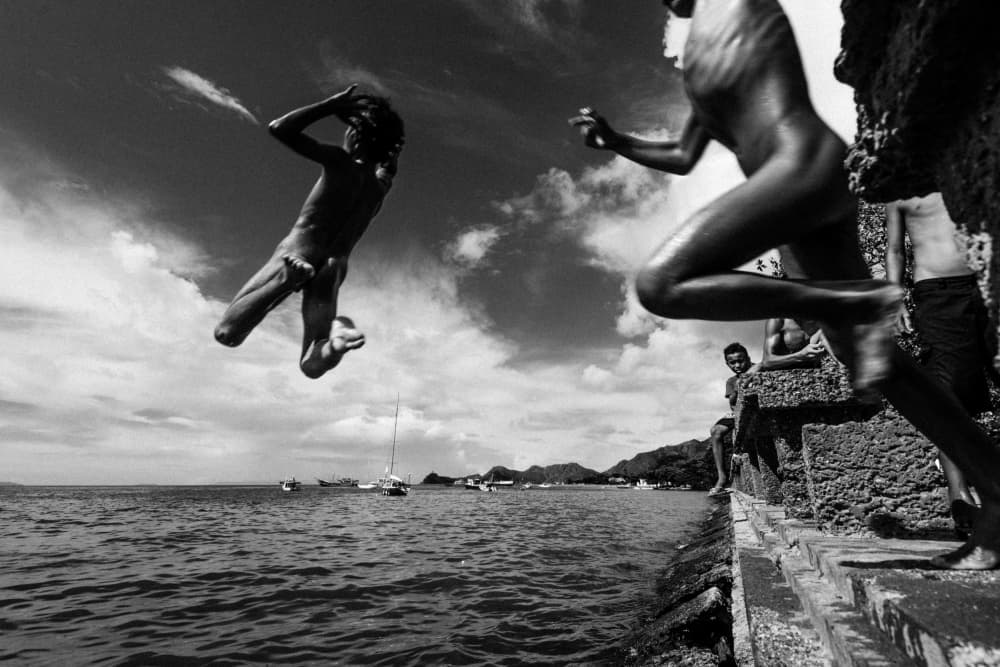 Boys Leaping Into Sea by Joao Galamba — canvas wall art