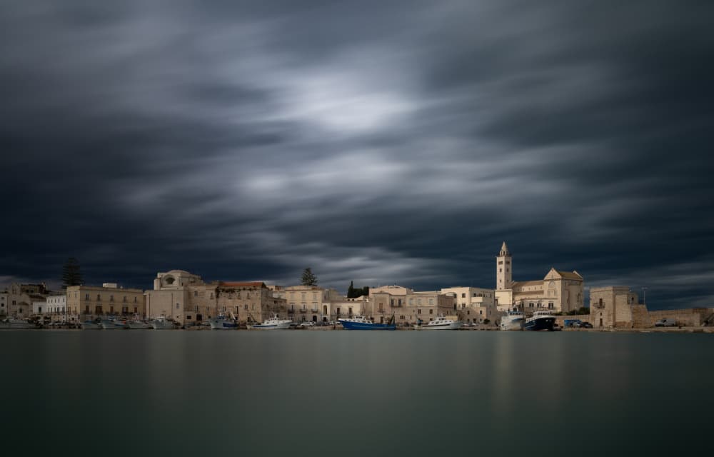 Moody Coastal Town by Dorian Gray — canvas wall art