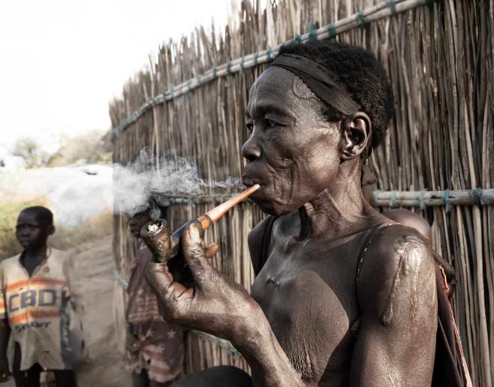 African Woman Smoking Pipe by Elena Molina — canvas wall art