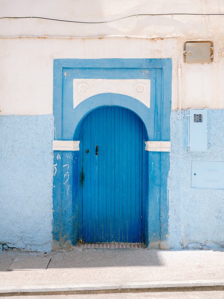 The Blue Door in Taghazout Morocco by Raisa Zwart — canvas wall art