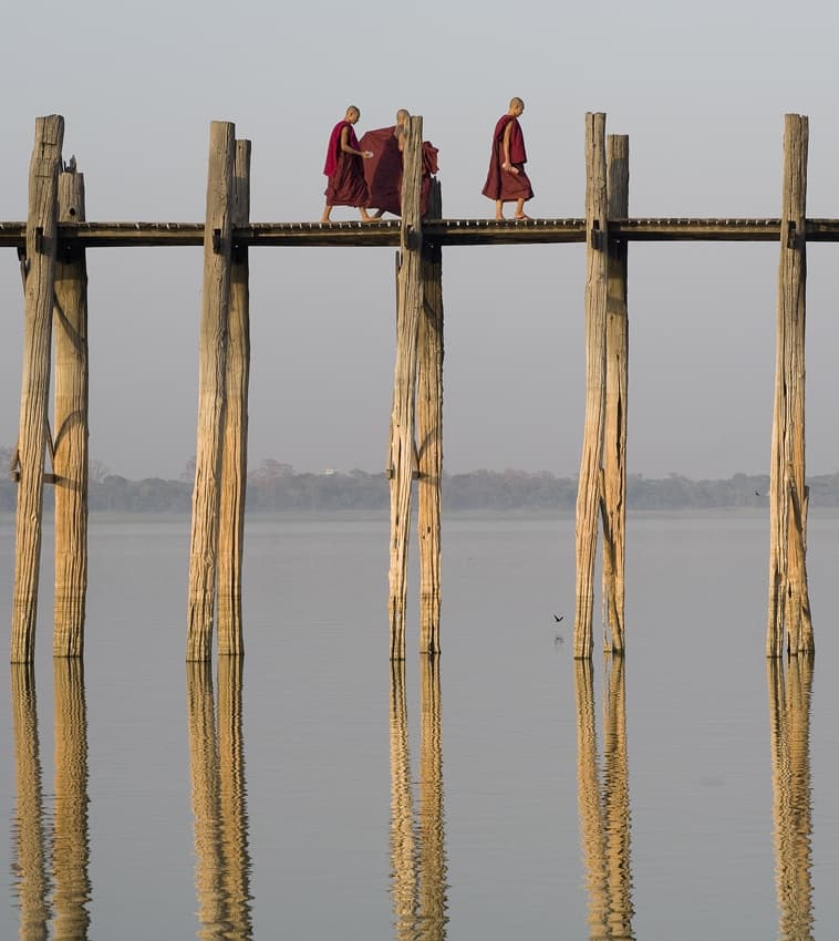 Monks on Wooden Bridge by Wayne Pearson — canvas wall art