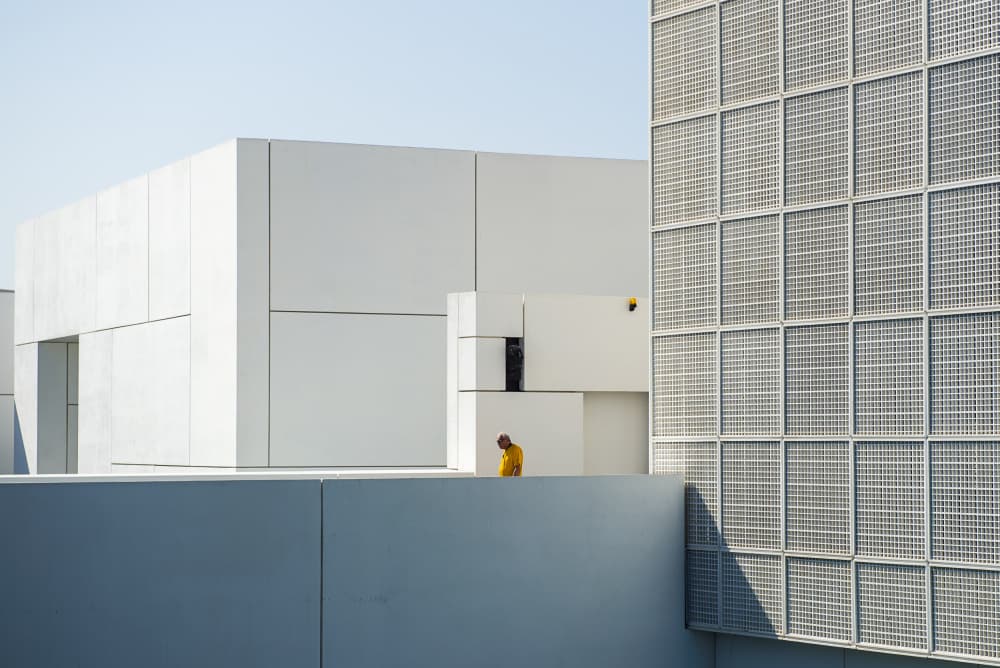 Yellow Figure White Architecture by Hasan Shaboot — canvas wall art