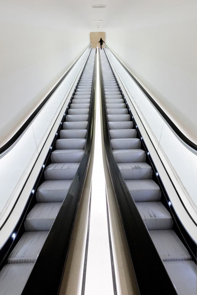 Lone Figure Escalator by Wilma Wijers Smeets — canvas wall art
