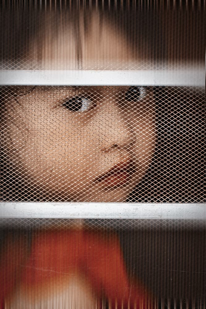 Child's Gaze Through Mesh by Andi Halil — canvas wall art
