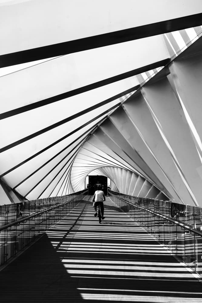 Cyclist on Spiral Bridge by Hasan Shaboot — canvas wall art