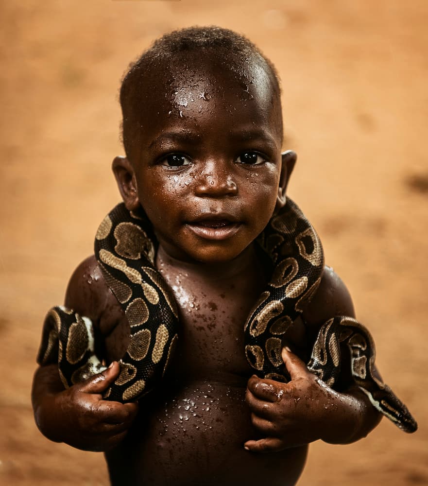 African Child And Python by Burak Senbak — canvas wall art