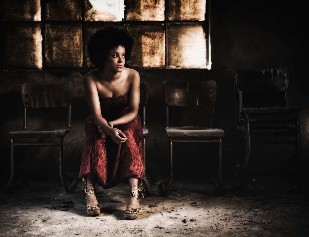 Black Woman Pensive Moment by Erkan Camlilar — canvas wall art