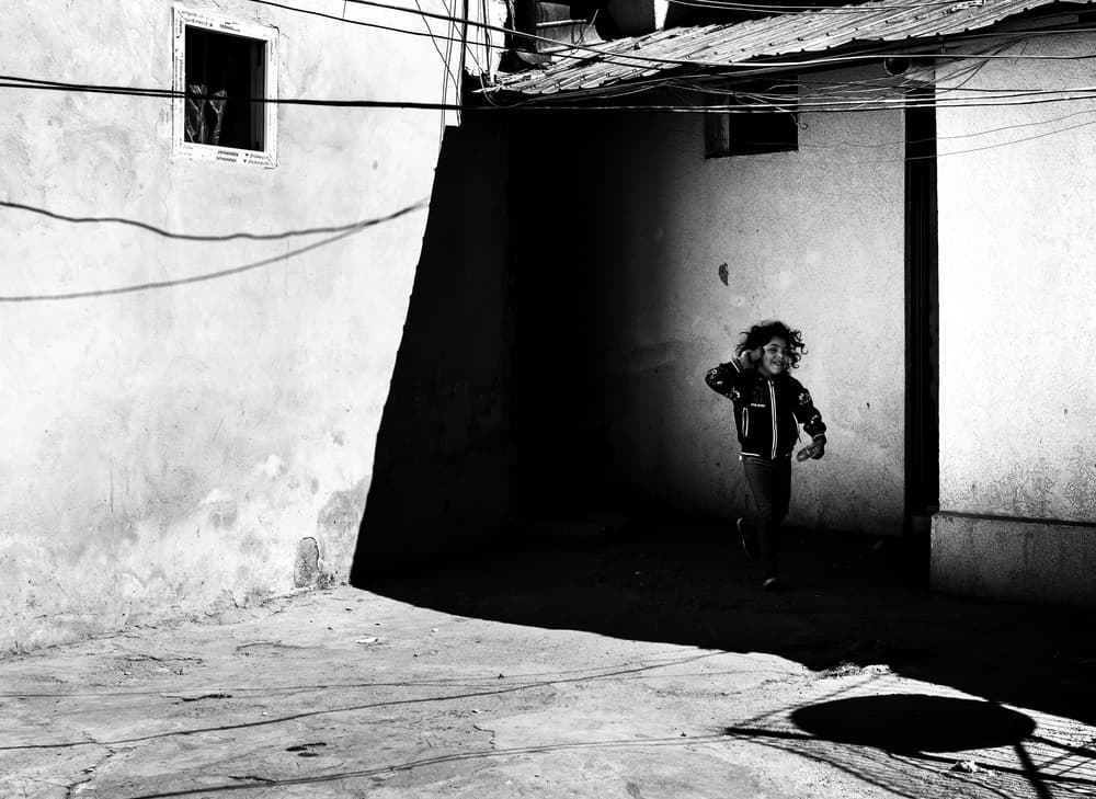 Child Running Through Shadows by Elena Raceala — canvas wall art