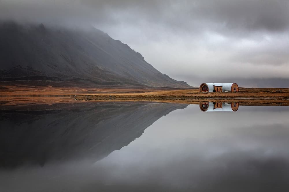 Serene Mountain Barn Reflection by Bragi Ingibergsson - BRIN — canvas wall art