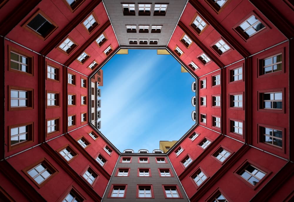Red Building Skyward View by Marc van Oostrum — canvas wall art