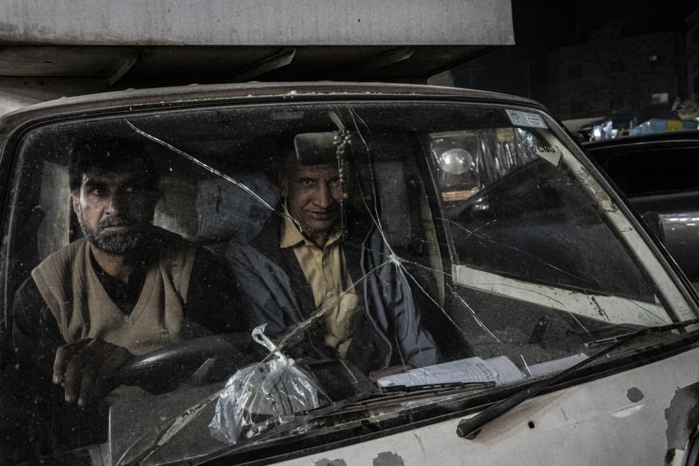 Two Men Through Glass by Elena Molina — canvas wall art