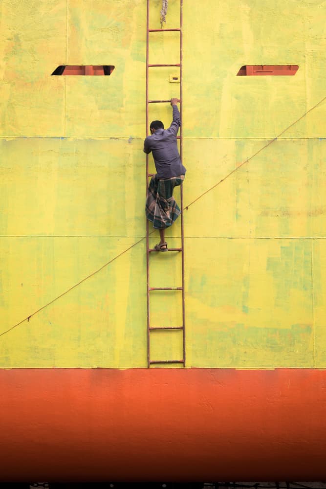 Man Climbing Yellow Ship by Richard Huang — canvas wall art