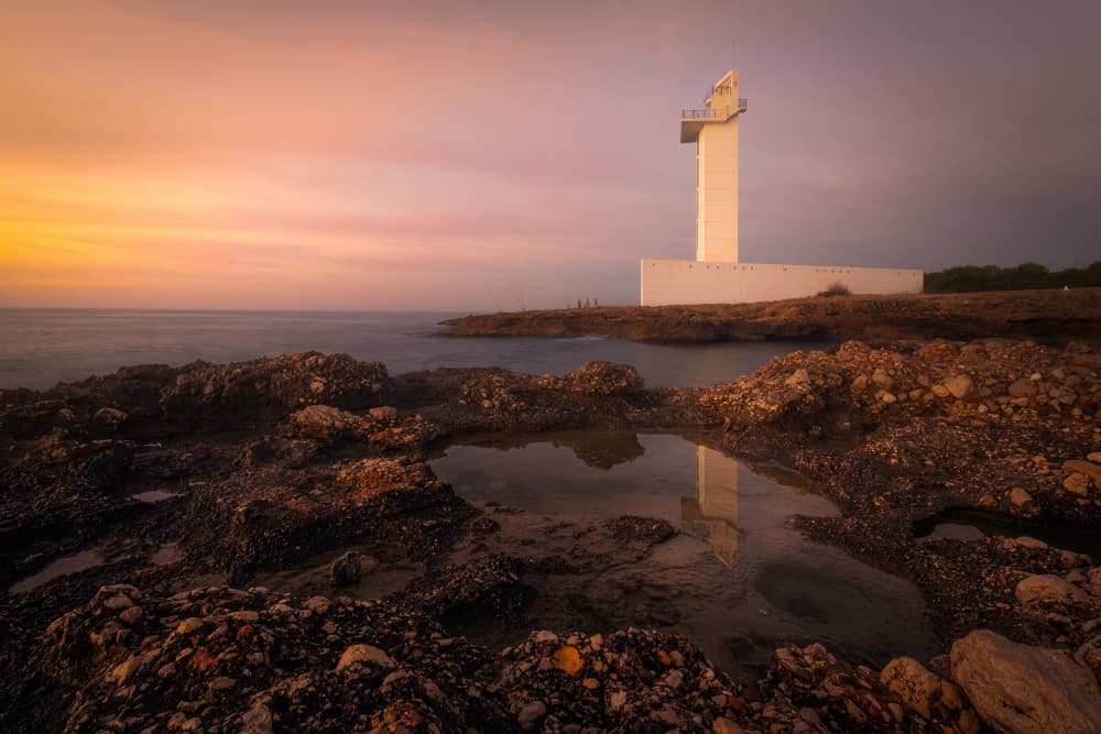 Sunset Lighthouse Reflection by Gustavo Ribes — canvas wall art