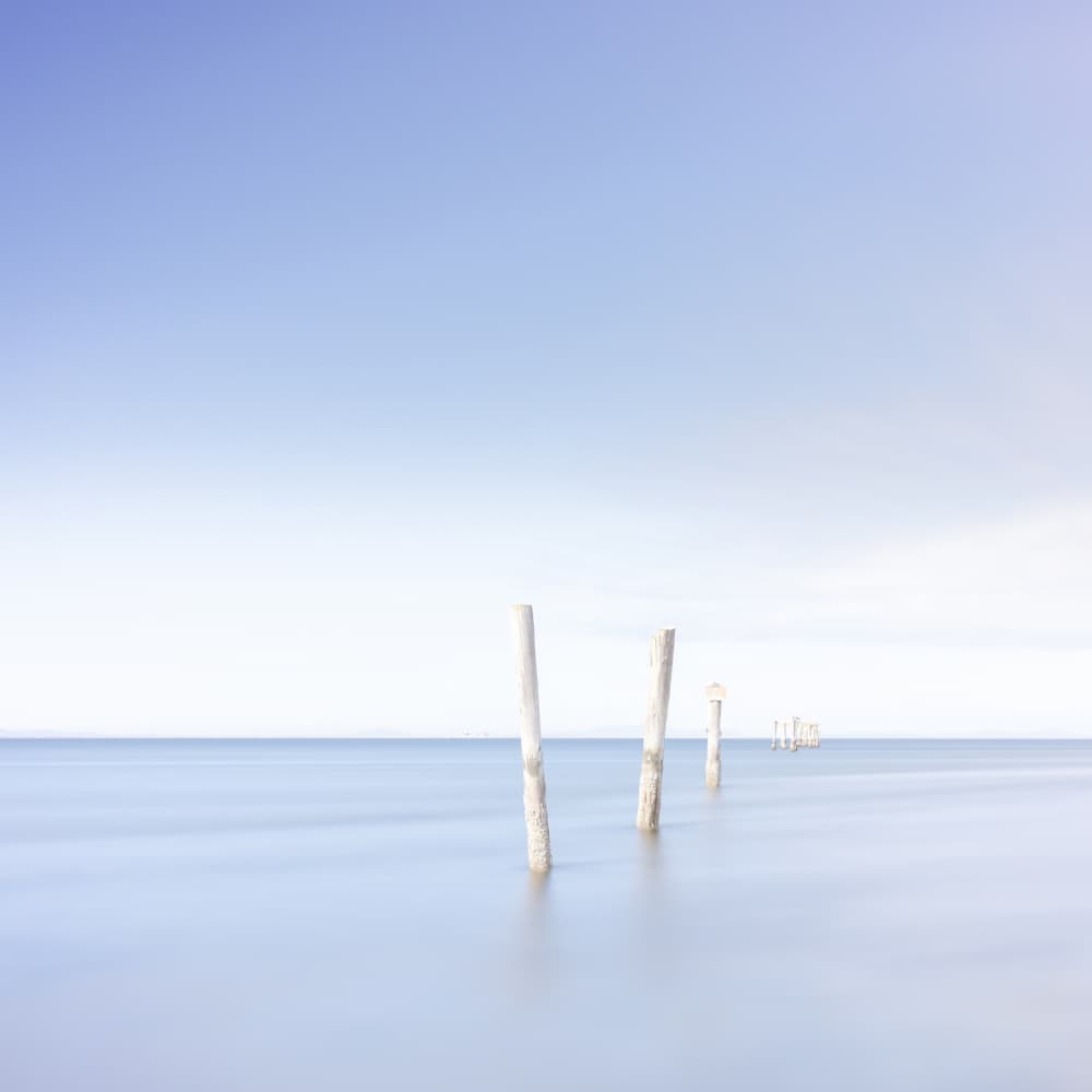 Serene Ocean Pilings by Lynann Colligan — canvas wall art