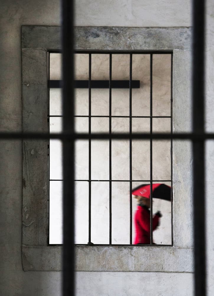 Red Umbrella Through Bars by Luciano Caturegli — canvas wall art