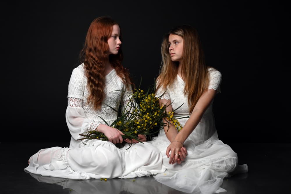 Sisters with Yellow Flowers by Iris Resch — canvas wall art