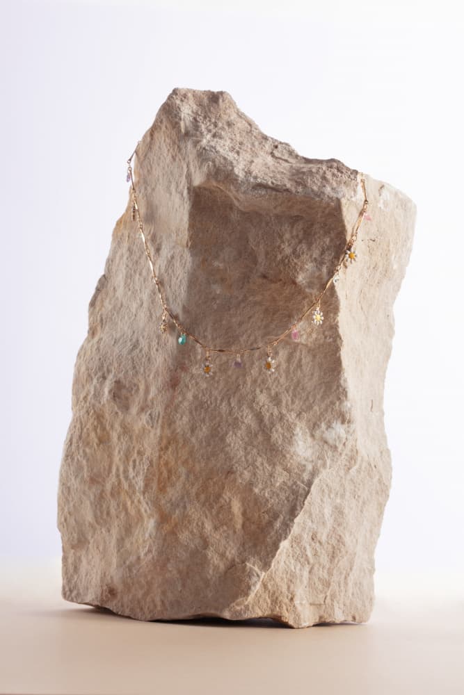 Gold Necklace on Stone by Julia Ramiro — canvas wall art