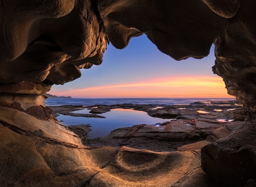 Coastal Cave Sunset by Jingshu Zhu — canvas wall art