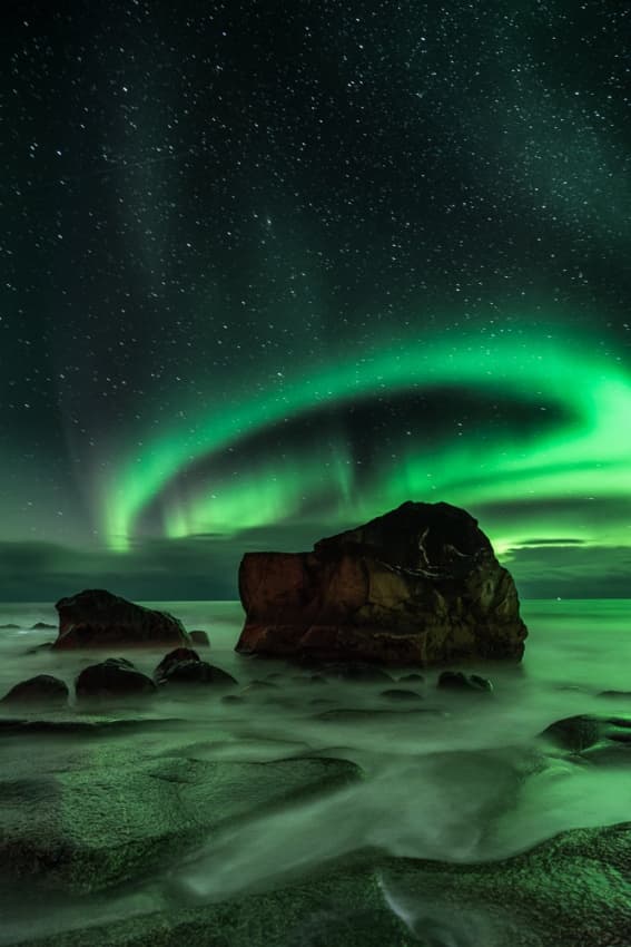 Green Aurora Ocean Rocks by Ajit Menon — canvas wall art