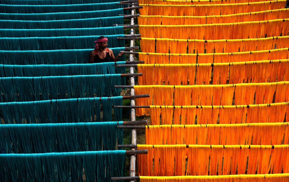 Man Drying Vibrant Textiles by Avishek Das — canvas wall art