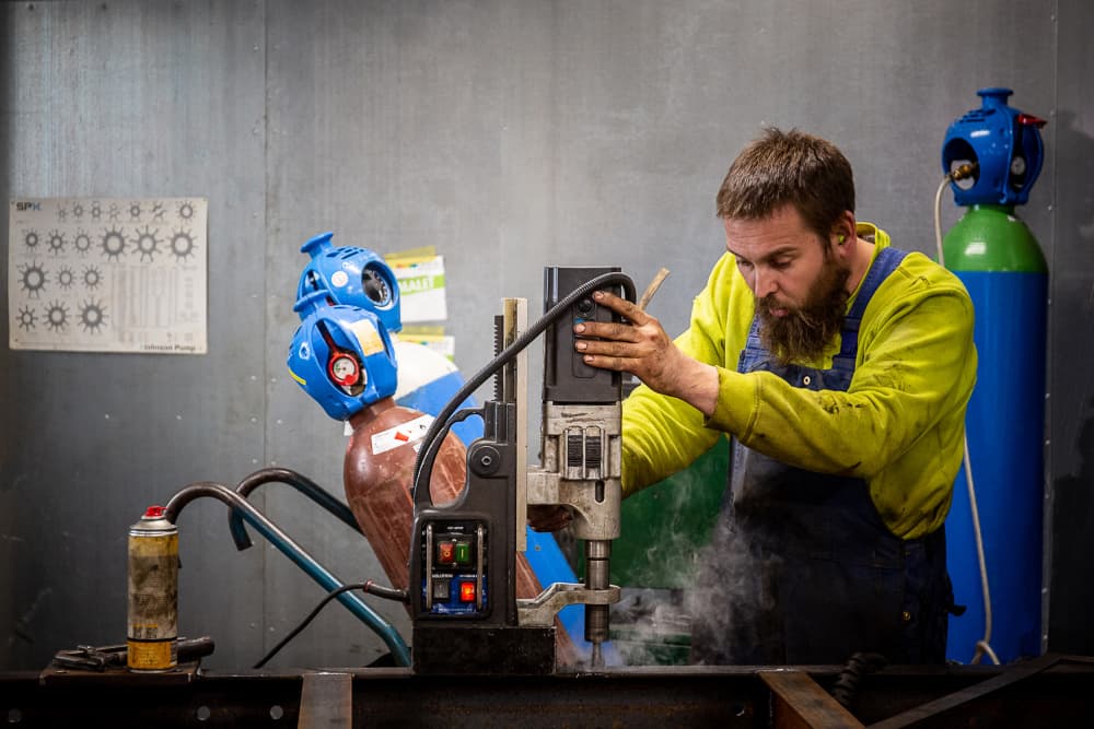 Industrial Worker Drilling Metal by Lars Hylleberg — canvas wall art