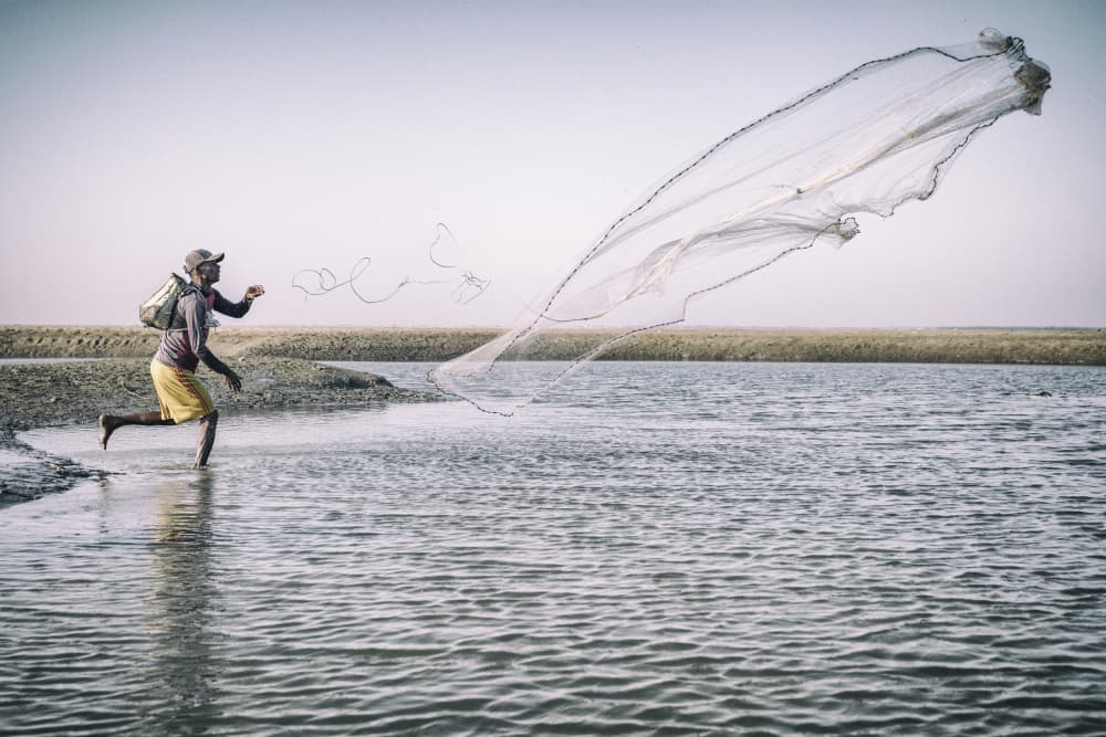 Fisherman Casting Net by Marcel Rebro — canvas wall art