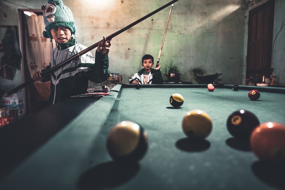 Boys Playing Pool by Marco Tagliarino — canvas wall art