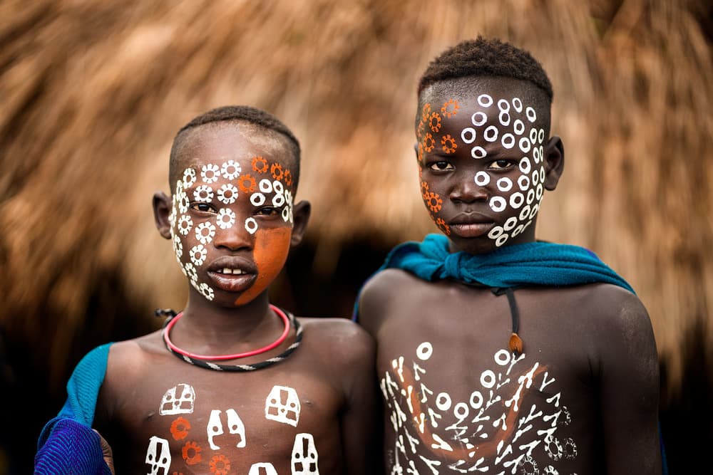 African Boys Painted Faces by Juanra Noriega — canvas wall art