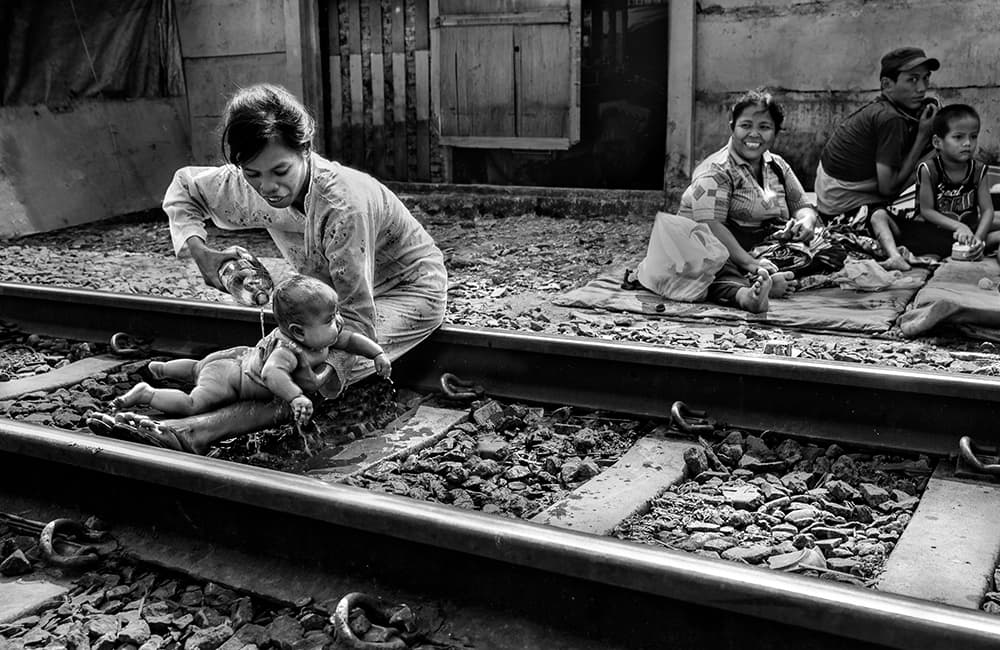 Bathing on Train Tracks by Sebastian Kisworo — canvas wall art