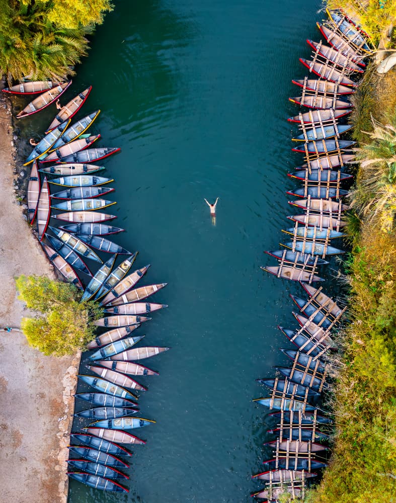 Swimmer Among Canoes by Gilad Topaz — canvas wall art