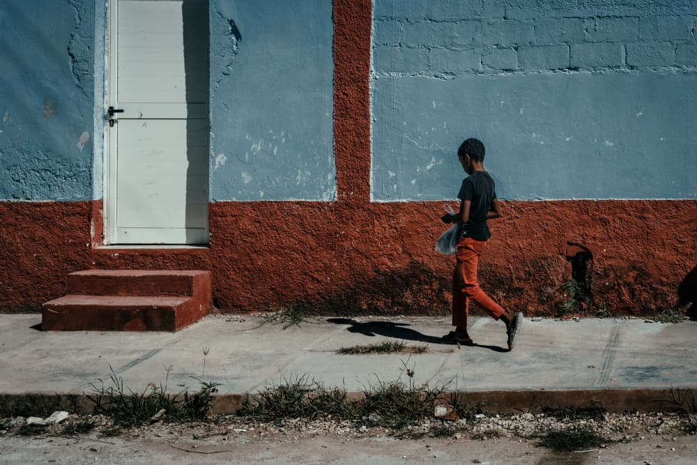Boy Walks Past Wall by Andy Bauer — canvas wall art