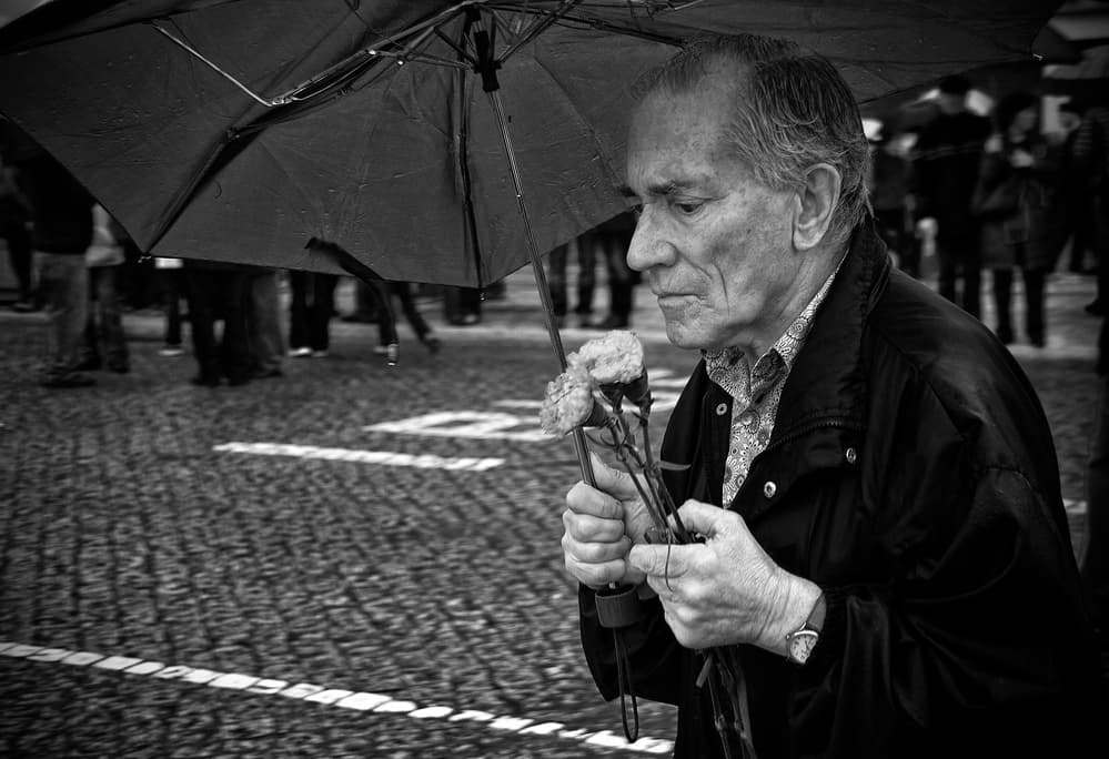 Man Under Umbrella With Flowers by Fernando Alves — canvas wall art