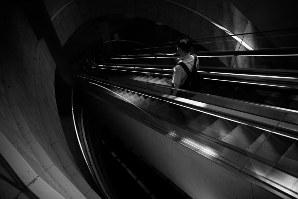 Solitary Escalator Ascent by Satoshi Hata — canvas wall art