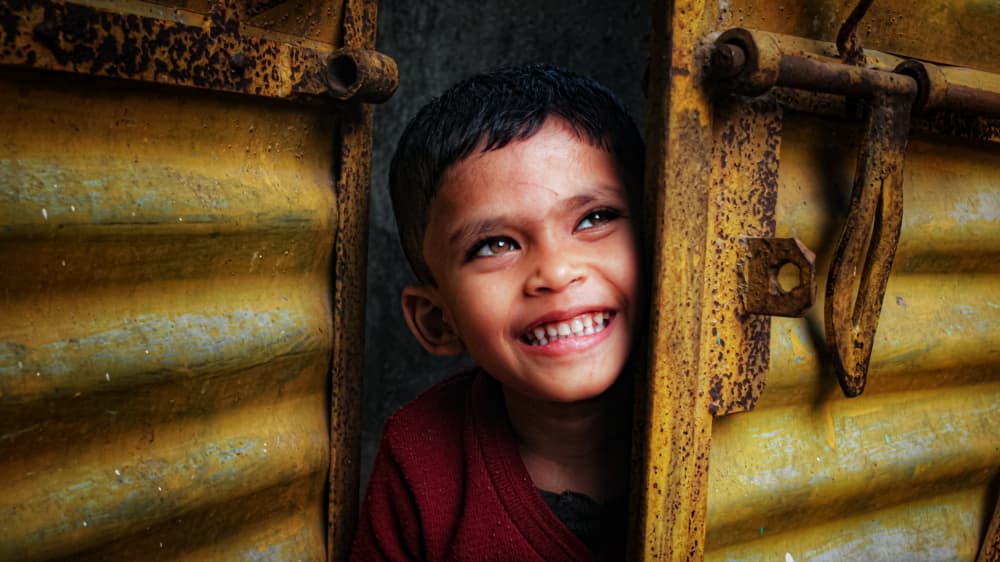 Joyful Child Peeking by RAJA MANDAL — canvas wall art