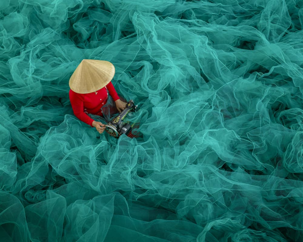 Woman Mending Fishing Nets by Joseph Ng — canvas wall art
