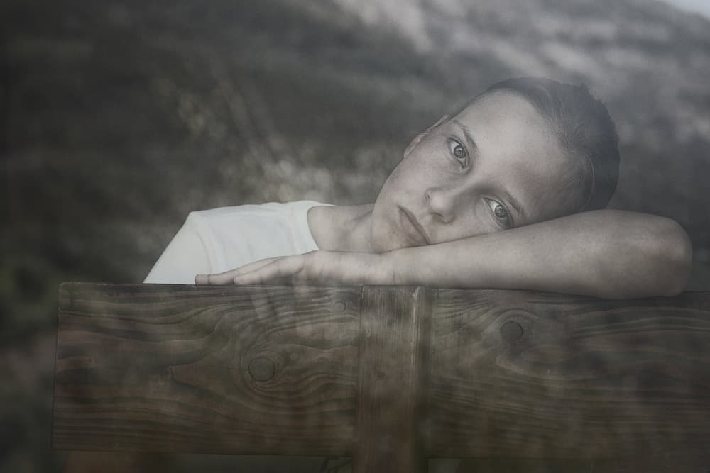 Pensive Child Outdoors by Mirjam Delrue — canvas wall art