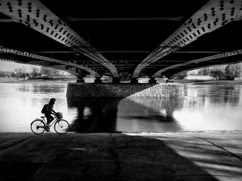 Cyclist Under Bridge Shadows by Wojciech Pokora — canvas wall art