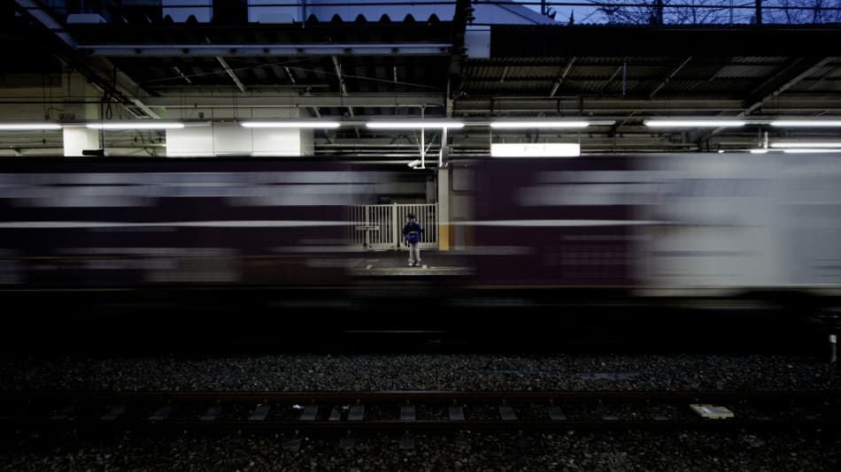 Solitary Figure Passing Train by Kouji Tomihisa — canvas wall art