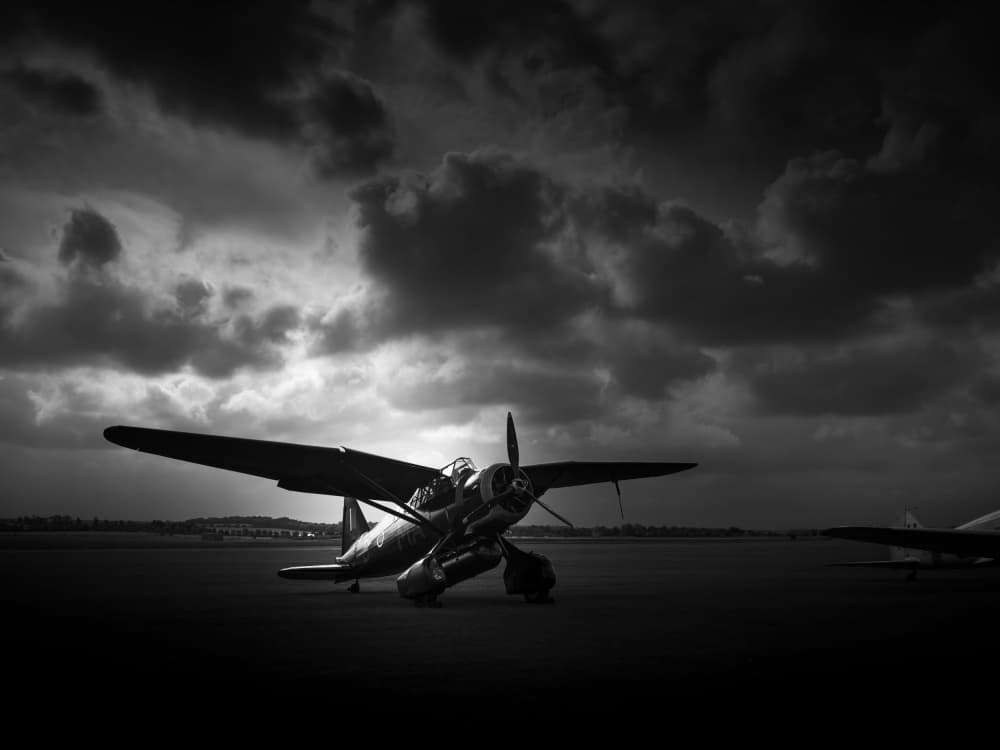 Warbird Under Storm Clouds by Lee Kershaw — canvas wall art